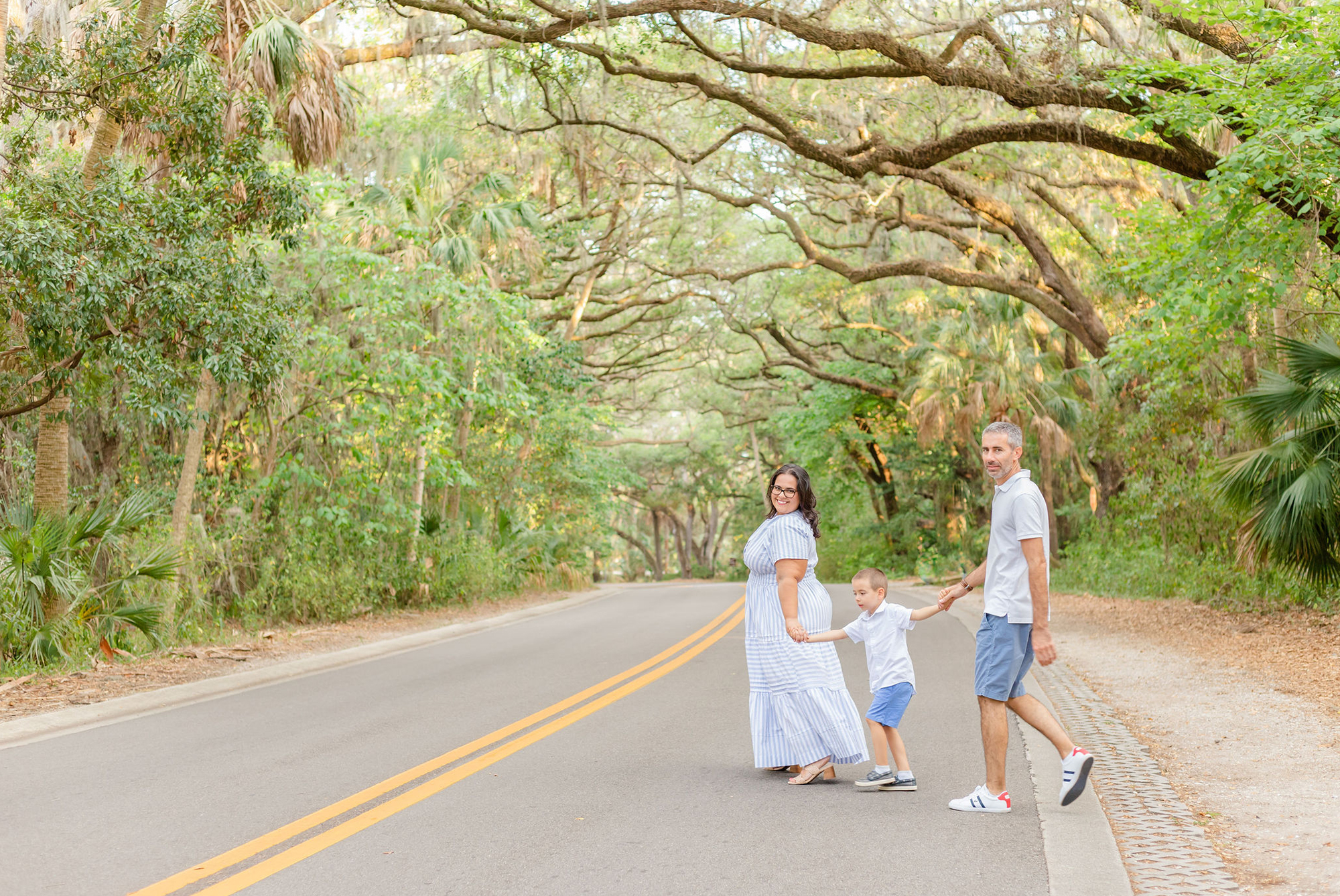 Spanish moss threes and family walking