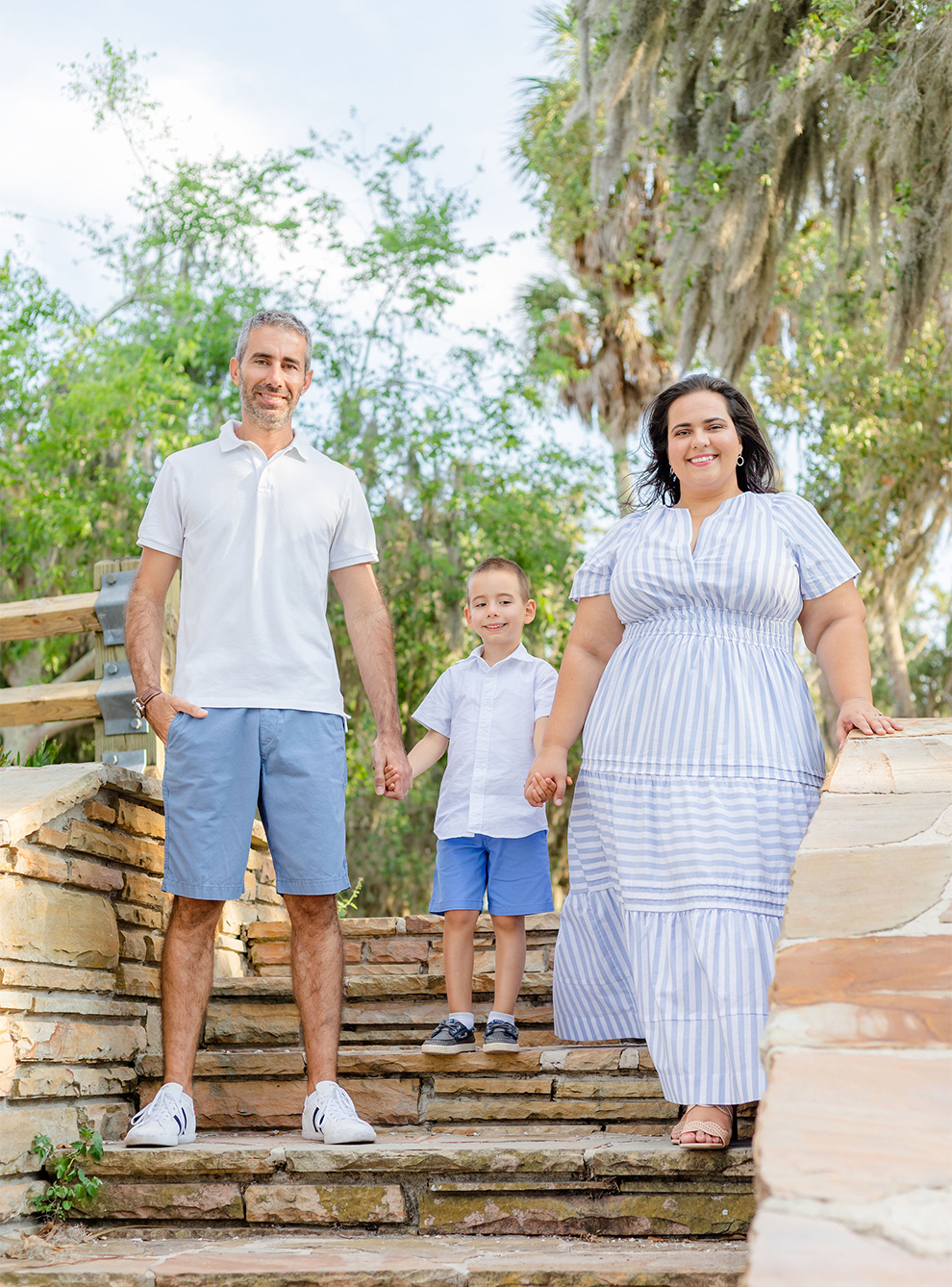 Family holding hands at the stairs at a park