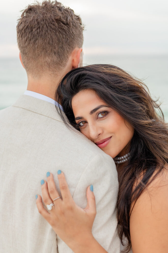 Bride resting her head on groom's shoulder at St. Pete Beach wedding portraits