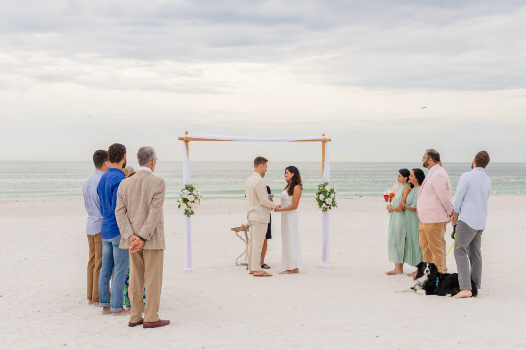 Beautiful setup of an intimate beach wedding with pastel decorations and ocean backdrop at Saint Pete Beach, Florida.