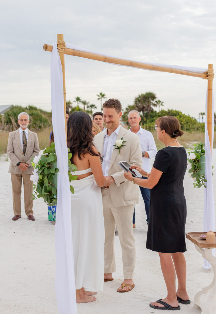 Beautiful setup of an intimate beach wedding with pastel decorations and ocean backdrop at Saint Pete Beach, Florida.