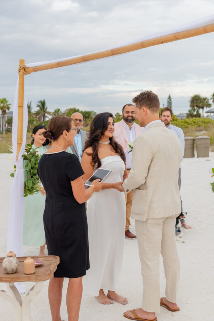 Beautiful setup of an intimate beach wedding with pastel decorations and ocean backdrop at Saint Pete Beach, Florida.