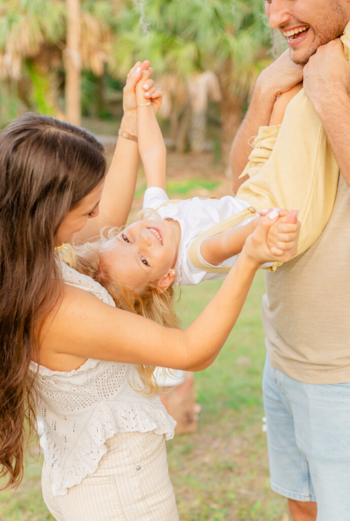 Parents playing with a little girl