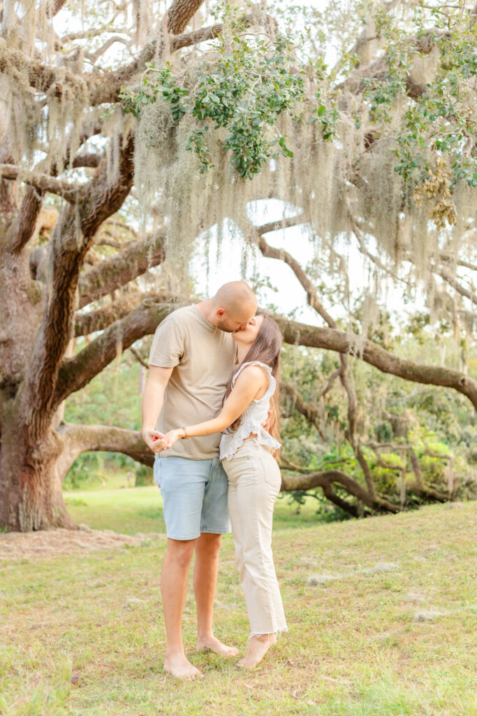 A couple at a park kissing 